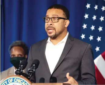  ?? PAT NABONG/SUN-TIMES ?? Ald. Michael Scott Jr. (with Mayor Lori Lightfoot in the background) speaks Wednesday during a news conference about Chicago Public Schools’ plans for remote learning in the fall.