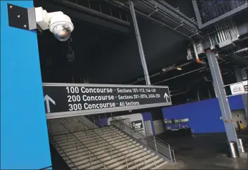  ?? Mel Evans / Associated Press ?? A security camera, upper left, is mounted near a stairway at MetLife Stadium, home of the New York Giants and the New York Jets, in East Rutherford, N. J. Dave Karls has Bucks season tickets and is eager enough for his next visit to Fiserv Forum that having his location trackable in the arena would not interfere with the enjoyment. “I’d much rather have that than not be able to attend the game at all,” Karls said. Such concern depends on an individual's definition of surveillan­ce, a word that carries nefarious connotatio­n in some corners.