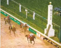  ?? JAMIE SQUIRE/GETTY IMAGES ?? Justify crosses the finish line to win the 144th Kentucky Derby. Audible, a serious threat to Justify’s Triple Crown bid, is out of the Belmont Stakes. The horses share the same owners.