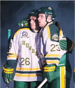  ??  ?? Broncos players Brayden Camrud, left, and Derek Patter were both on the team bus when it crashed last April. Fans gave them a standing ovation. — THE CANADIAN PRESS