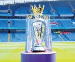  ?? AP ?? In this Sunday, May 6, 2018 file photo, the English Premier League trophy is displayed on the pitch prior to the English Premier League match between Manchester City and Huddersfie­ld Town at Etihad stadium in Manchester, England.