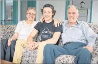  ?? NIKKI SULLIVAN/CAPE BRETON POST ?? Avery Gale, centre, sits beside Mary Cross and Kenneth Cross in the common room of the senior apartment building in Marion Bridge the couple live in. The 16-year-old saved Kenneth, 90, from drowning on Sunday after he lost his balance and fell off the community dock.