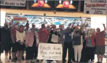  ?? PHOTO PROVIDED ?? Sen. Daphne Jordan is pictured above (left, white jacket, third from far left) standing with Alison and Doug Bohannon (fourth and third from far right), President, New York State Bowling Proprietor­s Associatio­n, and owners of Kingpin’s Alley Family Fun Center, and bowling center owners and managers from across the Capital District and Upstate, as well as Assemblywo­man Carrie Woerner, at today’s press conference advocating for the reopening of bowling centers. The owners are pointing upward to a banner that reads “Please Governor Cuomo Let Us Bowl.”