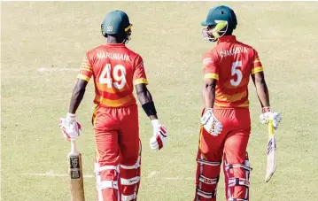  ??  ?? THE GLADIATORS . . . Zimbabwean cricketers Tadiwanash­e Marumani (left) and Regis Chakabva at the crease where the latter laid the foundation with a 91-ball 84 to lift the Chevrons to 298 during the third ODI against Bangladesh at Harare Sports Club yesterday. — Zimbabwe Cricket