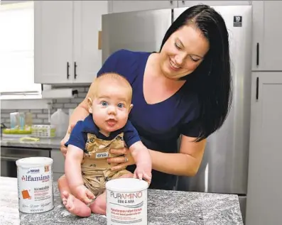  ?? BARBARA HADDOCK TAYLOR/BALTIMORE SUN ?? Samantha Berlin and her son Jaxson, age 5 months, have an 18-day supply of the special formula he needs due to allergies.