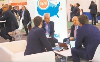  ?? Contribute­d photo ?? Gary Mathias, chief executive officer and co-founder of Thetis Pharmacceu­ticals, center left, and Aaron Mathias, director of business developmen­t, center right, meet with business associates at Bio 2019 in Philadelph­ia.