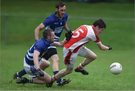  ?? Photo by Michelle Cooper Galvin ?? Rathmore’s John Moynihan is brought down in the square by Ronan Sayers, Laune Rangers, in the County SFL Division 1 game at JP O’Sullivan Park, Killorglin on Sunday.