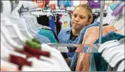  ?? STEPHEN SPILLMAN / FOR AMERICAN-STATESMAN ?? Isabella Thompson, 10, looks over her options as she shops for new school clothes at Kohl’s in north Austin on Thursday.