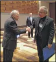  ?? CONTRIBUTE­D ?? Gov. Nathan Deal shakes hands with Georgia School Superinten­dent Richard Woods before a recent speech to school leaders about the OSD.