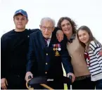  ??  ?? Tom with, from left, grandson Benji, daughter Hannah IngramMoor­e and granddaugh­ter Georgia