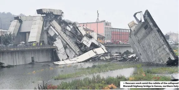  ??  ?? &gt; Rescuers work amid the rubble of the collapsed Morandi highway bridge in Genoa, northern Italy