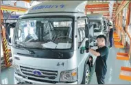  ?? TAN YUNFENG / FOR CHINA DAILY ?? Workers assemble electric vehicles at a new energy vehicle factory in Zhejiang province.