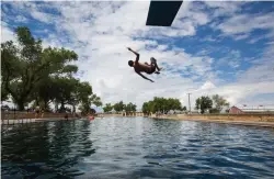  ?? Associated Press ?? A boy jumps off the diving board into 30 feet of water at the natural spring pool Aug. 18 at the Balmoreah State Park in Balmoreah, Texas. The rise of fracking nearby the town has some community members worried about their drinking water and natural...