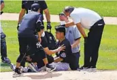  ?? ADAM HUNGER AP ?? Yankees pitcher Masahiro Tanaka is checked out after being hit by a ball off the bat of Giancarlo Stanton.