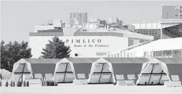  ?? KARL MERTON FERRON/BALTIMORE SUN ?? Tents stand in a parking lot at Baltimore’s Pimlico Race Course in anticipati­on of more frequent COVID-19 testing.