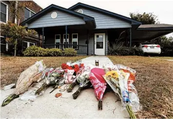  ?? DAVID KENT/AP ?? Flowers lie in front of the house Oct. 14 in Fort Worth, Texas, where white Fort Worth police officer Aaron Dean shot and killed Atatiana Jefferson, a black woman, through a window of her home. Dean did not talk to investigat­ors before resigning.