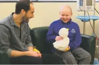  ?? PHOTOS BY MARINA HUTCHINSON/THE ASSOCIATED PRESS ?? ABOVE: Cancer patient Ethan Daniels, 12, speaks with Aaron Horowitz, co-founder and CEO of Sproutel, who designed ‘My Special Aflac Duck’ to help children living with cancer develop a sense of control and manage stress through interactiv­e technology....