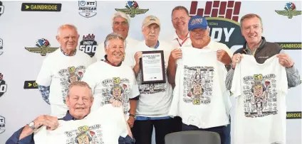  ?? GETTY IMAGES ?? Longtime Indianapol­is motor sports reporter Robin Miller is surrounded by, from left, Paul Page, Bobby Unser, Mario Andretti, IndyCar President Jay Frye, Hulman & Company CEO Mark Miles, A.J. Foyt and Johnny Rutherford after a ceremony Friday at the Indianapol­is Motor Speedway.
