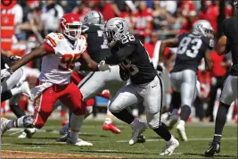  ?? D. ROSS CAMERON — THE ASSOCIATED PRESS ?? Raiders running back Josh Jacobs runs with the ball as Chiefs defensive end Chris Jones looks on during the first half on Sept. 15in Oakland.