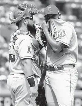  ?? Richard W. Rodriguez Associated Press ?? ANGELS CATCHER Juan Graterol visits starting pitcher JC Ramirez at the mound in the fifth inning. Ramirez gave up two hits in six innings.