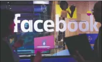  ?? The Associated Press ?? F8 DEVELOPER CONFERENCE: In this April 18, 2017, photo, conference workers speak in front of a demo booth at Facebook’s annual F8 developer conference, in San Jose, Calif. Facebook is facing the most serious crisis in its 14-year history as it deals...