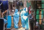  ?? PIC/PTI ?? Health workers wearing protective suits screen the residents of Naik Nagar during a house-to-house health survey, after detection of some COVID-19 positive cases, at Dharavi in Mumbai, Wednesday