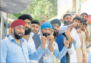  ?? AP ?? ■ Afghan Sikhs show their inked fingers after casting their votes at a polling station in the city of Jalalabad, east of Kabul, on Saturday.