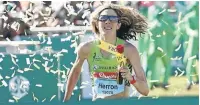  ??  ?? Ladies winner, American Camille Herron, crosses the finish line at yesterday’s Comrades