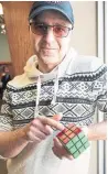  ?? NIKKI WESLEY/METROLAND ?? With EnChroma glasses, Jack Sansone began to see the difference between green and red on the Rubik’s Cube.