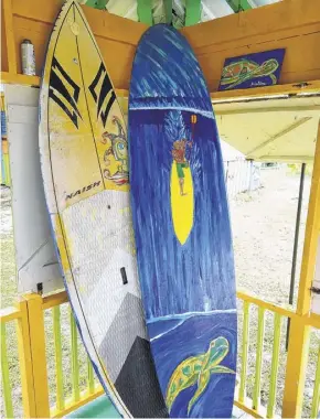  ??  ?? Repurposed surfboards are now artwork by worldclass windsurfer Brian Talma.