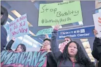  ?? CHRIS SWEDA/CHICAGO TRIBUNE VIA AP ?? People with Asian community organizati­ons from Chicago hold signs to protest David Dao’s removal from a United Airlines during rally Chicago’s O’Hare Internatio­nal Airport on Tuesday. Dao will require reconstruc­tive surgery his lawyer says.