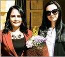  ??  ?? Head teacher Eylem Varoğlu (left) presents a bouquet to Gizem Cemaller