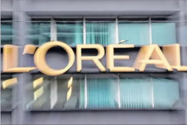  ?? CP PHOTO ?? French cosmetics conglomera­te L’Oreal is buying Canadian augmented reality and artificial intelligen­ce firm ModiFace, which caters to the beauty industry. The logo of cosmetics group L’Oreal is pictured with a zoom effect during a visit at L’oreal...