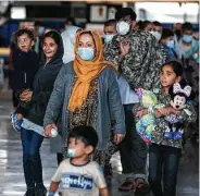  ?? Anna Moneymaker / Getty Images ?? An evacuated Afghan family arrives Wednesday at Dulles Internatio­nal Airport in Virginia.