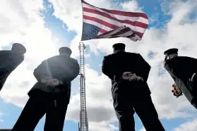  ?? Helen H. Richardson, The Denver Post ?? Boulder Fire Department firefighte­rs line South Boulder Road as they honor the procession for Officer Eric Talley. His funeral Tuesday was at Flatirons Community Church in Lafayette.