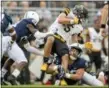  ?? ABBY DREY — CENTRE DAILY TIMES VIA AP ?? Penn State linebacker Jan Johnson trips up Appalachia­n State wide receiver Thomas Hennigan during an NCAA college football game Saturday in State College, Pa.