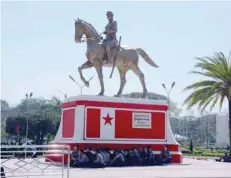  ?? — Reuters ?? Police wait under the statue of General Aung San, Myanmar’s independen­ce hero and the father of Aung San Suu Kyi in Loikaw, Kayah state, on Tuesday.