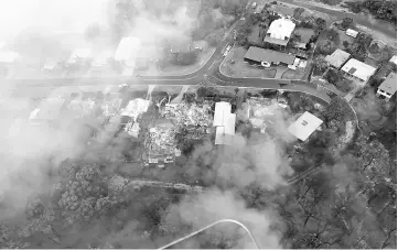  ??  ?? This handout aerial picture shows homes burning in the fires which devastated the seaside town of Tathra. — AFP photo