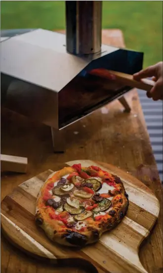  ?? GETTY IMAGES ?? A portable pizza oven, which cooks tasty pies in two minutes flat, makes a backyard pizza party easy.