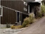  ??  ?? Above The stair has screened the entry from the shared driveway that runs up the side of the property.
Right Architect Ben Lloyd perches against the wall on one of the chunky timber risers, which are designed to create active spaces.