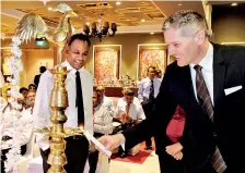  ??  ?? Movenpick GM George Koumendako­s lighting the oil lamp.