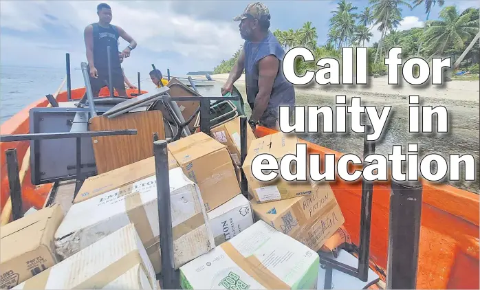  ?? Picture: SUPPLIED ?? Dedicated volunteers Pauliasi and Savenaca on their way to Fulaga District School at Muanaicake Village, to deliver desks and chairs.