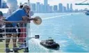  ?? JOE CAVARETTA/STAFF PHOTOGRAPH­ER ?? Passengers aboard the Fathom Adonia watch as the ship leaves PortMiami bound for Havana on Sunday.