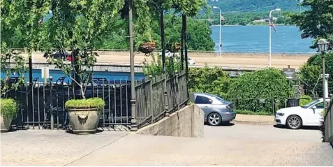  ?? PHOTO BY SUSAN PIERCE ?? The view from Tony’s or Back Inn Cafe in Bluff View Art District looks out across Veterans Bridge and the Tennessee River. Patios are shaded by leafy canopies of vines entwined with white mini lights.
