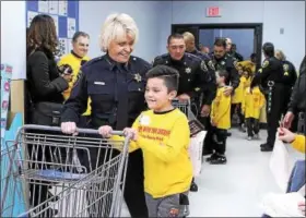  ?? CHRIS BARBER — DIGITAL FIRST MEDIA ?? Sheriff Carolyn “Bunny” Welsh and her student, William, set out to find gifts for his relatives.