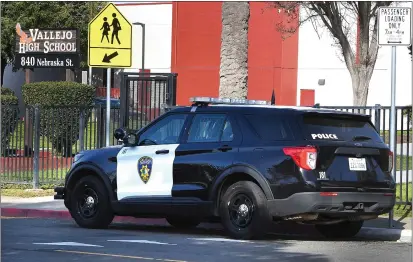  ?? CHRIS RILEY — TIMES-HERALD ?? A Vallejo police vehicle is parked in front of Vallejo High School as an increased police present is visible Wednesday after a female student was grazed by a stray bullet from a drive-by shooting Tuesday.