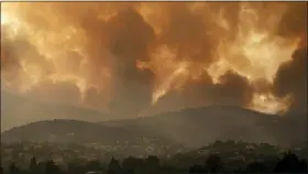  ?? LEFTERIS PITARAKIS — THE ASSOCIATED PRESS ?? Smoke spreads over Parnitha mountain during a wildfire in Ippokratio­s Politia village, about 21miles, northern Athens, Greece, Friday, Aug. 6. Thousands of people fled wildfires burning out of control in Greece and Turkey on Friday, including a major blaze just north of the Greek capital of Athens that claimed one life, as a protracted heat wave left forests tinder-dry and flames threatened populated areas and electricit­y installati­ons.