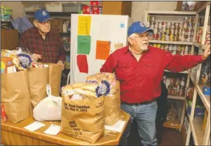  ?? The Sentinel-Record/Richard Rasmussen ?? COMMUNITY SUPPORT: Frank Rysan, left, and Frank Mantell, both of Hot Springs Village, package food bags at Jackson House Monday. Executive Director Janie Smith said Monday the organizati­on needs the community’s support, especially during the holidays.