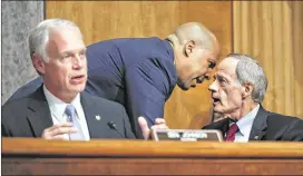  ?? PABLO MARTINEZ MONSIVAIS / ASSOCIATED PRESS ?? U.S. Sen. Cory Booker, D-N.J., leans in Tuesday to talk to fellow Senate Homeland Security Committee member Tom Carper, D-Del. At left is the commission’s chairman, U.S. Sen. Ron Johnson, R-Wis.