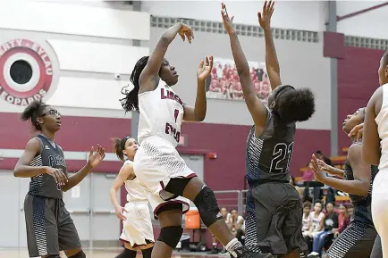  ?? Photo by Kevin Sutton ?? LibertyEyl­au’s Taylor Crabtree shoots over Paris defender Courtasia Dowdy on Friday at the Rader Dome. The Lady Leopards won, 72-57, in both teams’ District 14-4A opener.